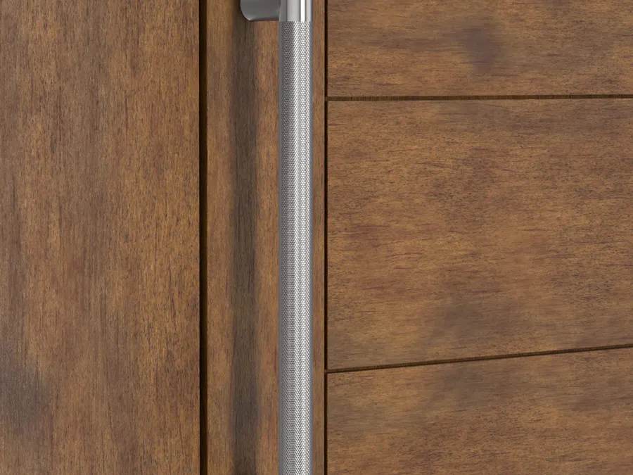 Vertical stainless steel door pull with a diamond knurled center grip and two round standoffs, mounted on a medium brown stained wood door.