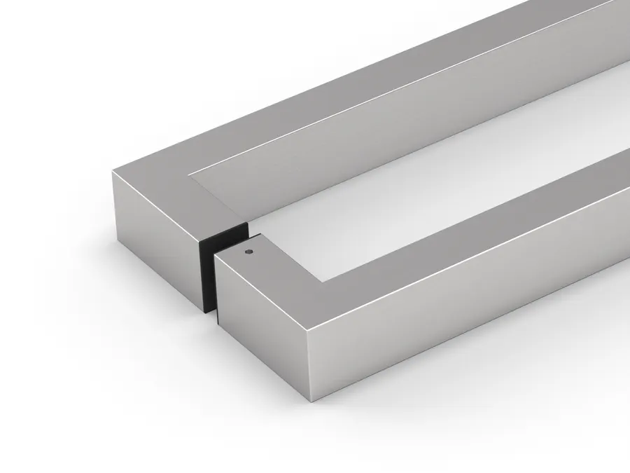 Close view of two polished chrome square bars meeting back to back through a door, with a dark gasket and a small fixing hole visible at the junction.