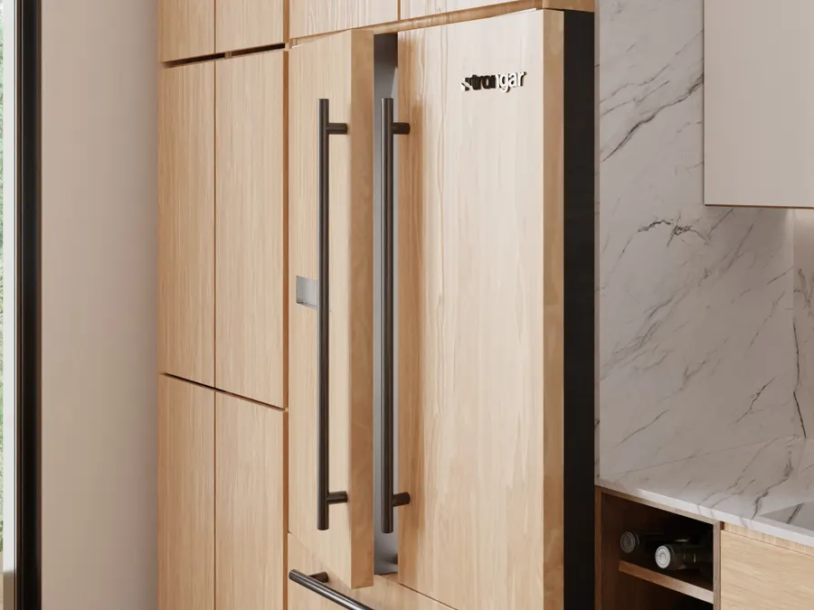 A wall of pale oak kitchen cabinetry with an integrated refrigerator wearing two long black bar pulls and a slim stainless drawer pull, a marble backsplash and an angled wine rack at right.