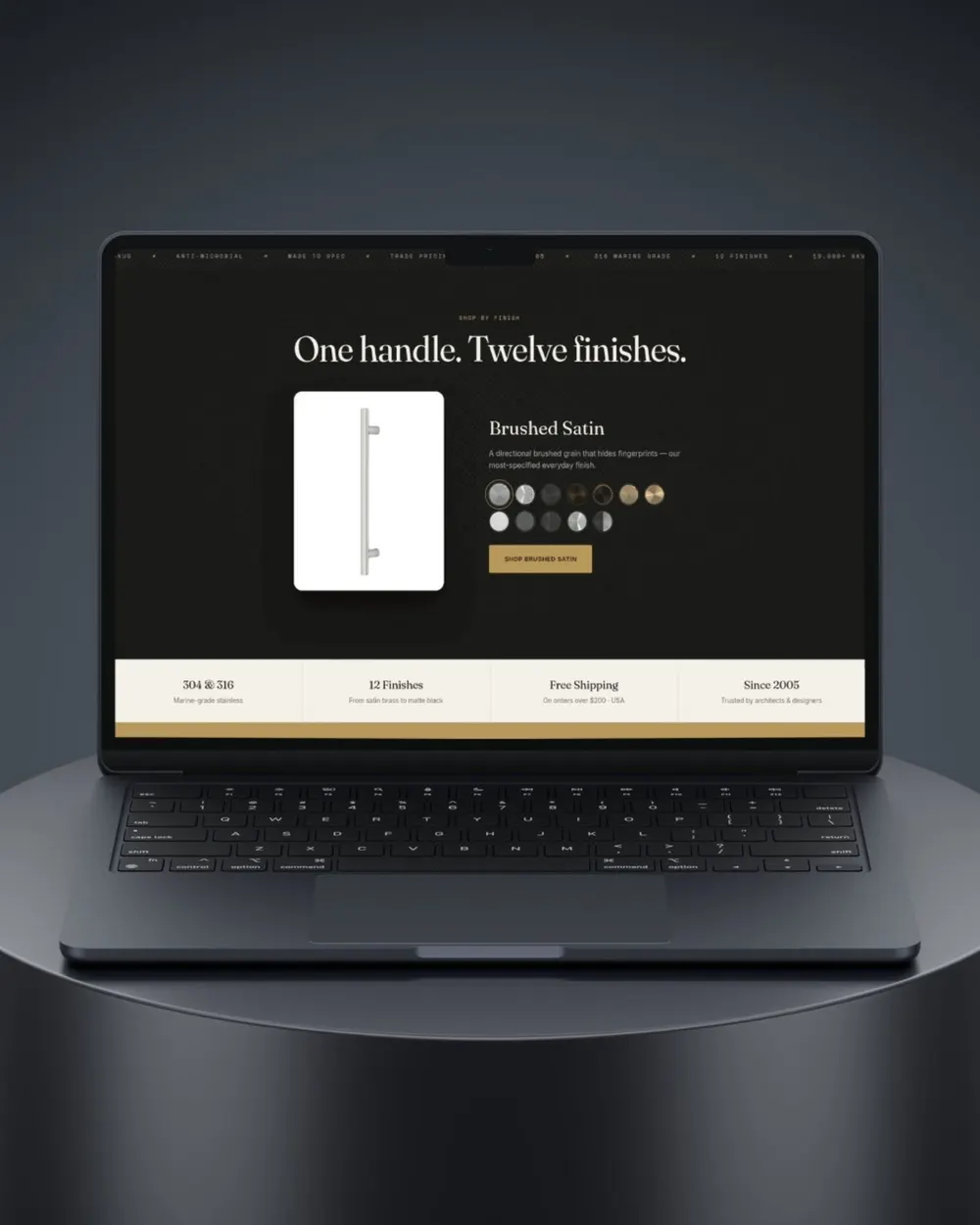 A laptop on a dark pedestal showing a product page headed One handle. Twelve finishes, with a row of finish swatches.