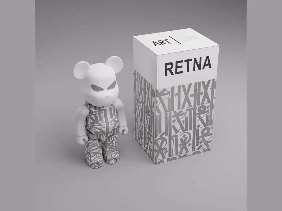 A patterned collectible figure standing beside its printed carton.